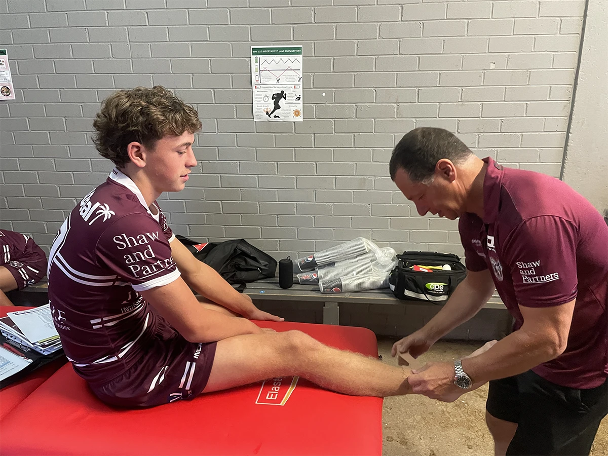 Player at Sports and Spine Physiotherapy in Brookvale - Northern Beaches receiving expert physiotherapy taping and sports injury treatment.